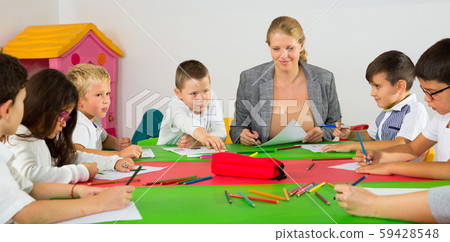 Cute schoolchildren drawing with teacher Cute schoolchildren drawing with teacher 59428548