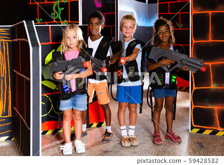 Group of smiling tweenagers with laser guns Group of smiling tweenagers with laser guns 59428582