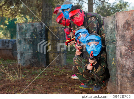 Group of glad kids playing paintball Group of glad kids playing paintball 59428705
