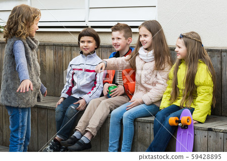 Group of laughing children playing charades 59428895