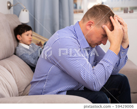 Upset man after quarrel with son Upset man after quarrel with son 59429006