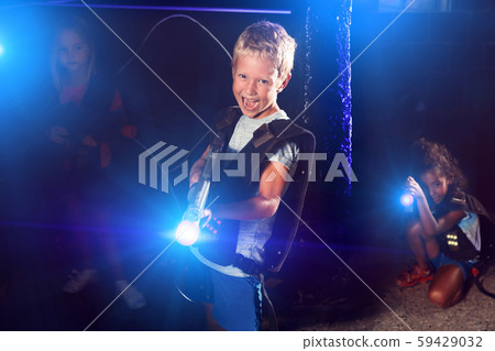 Portrait of cheery tweenager boy with laser gun Portrait of cheery tweenager boy with laser gun 59429032