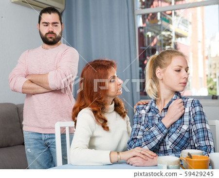 Mother comforting young daughter after a family conflict Mother comforting young daughter after a family conflict 59429245