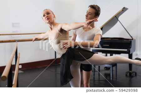 Ballet partners dancing gracefully together in the ballet studio Ballet partners dancing gracefully together in the ballet studio 59429398
