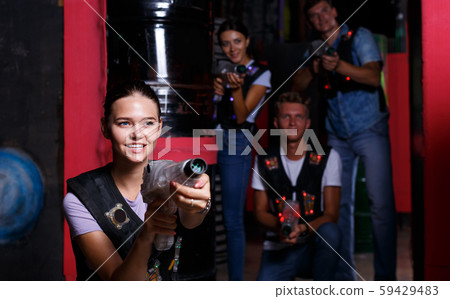 Smiling girl with laser guns took aim and having fun with friends 59429483