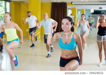 Group of young women and men exercising 59429832