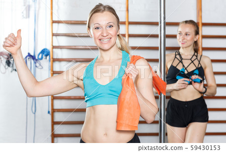 Happy woman standing near pylon 59430153