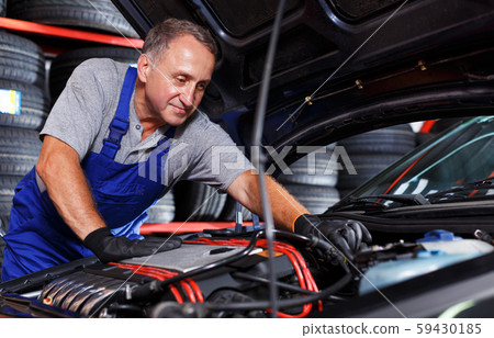 man mechanic engaged in car repair man mechanic engaged in car repair 59430185