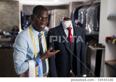 Afro-american man buyer in shirt choosing colored tie in the dress shop Afro-american man buyer in shirt choosing colored tie in the dress shop 59430186