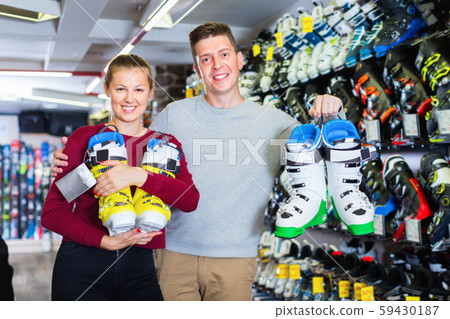 Woman and man are demonstrating their choice of ski boots 59430187