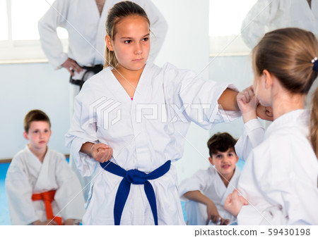 Young female children are trying in sparring to use new moves Young female children are trying in sparring to use new moves 59430198