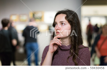 Positive woman visiting museum and thinking Positive woman visiting museum and thinking 59430456