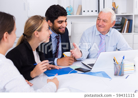 Employees are working together at computer Employees are working together at computer 59431115