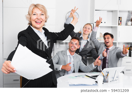 Businesswoman and team delighted with achievements Businesswoman and team delighted with achievements 59431209