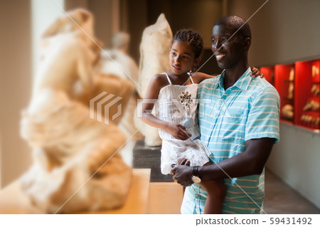 Man and his daughter looking at exhibits Man and his daughter looking at exhibits 59431492