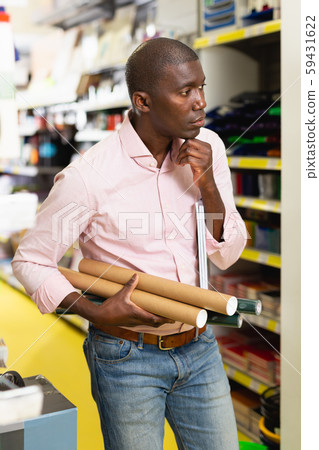 African man choosing office supplies African man choosing office supplies 59431622