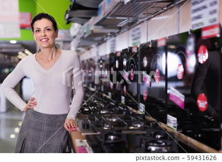 Young female chooses in shop of household appliances cooktop 59431626