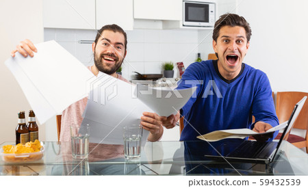 Men discuss and sign apartment sale contract agreement at home Men discuss and sign apartment sale contract agreement at home 59432539