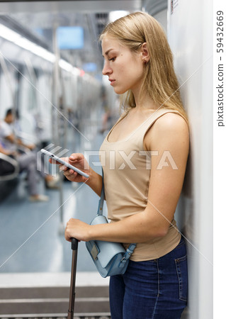 Woman using phone inside subway 59432669