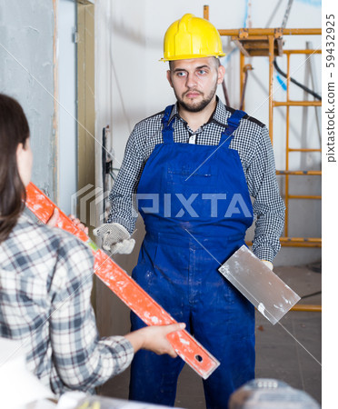 Female customer is checking what worker done Female customer is checking what worker done 59432925