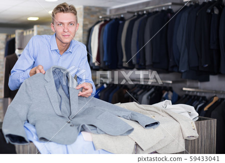 positive male customer choosing jacket positive male customer choosing jacket 59433041