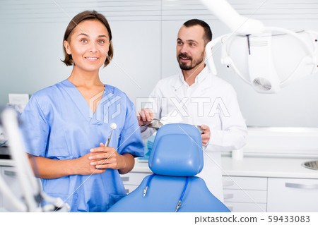 doctor with assistant are posing on workplace in hospital 59433083