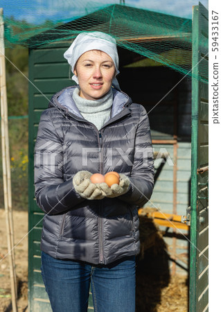 Woman holding raw chicken eggs 59433167