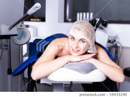 Woman getting cosmetological body procedure Woman getting cosmetological body procedure 59433290