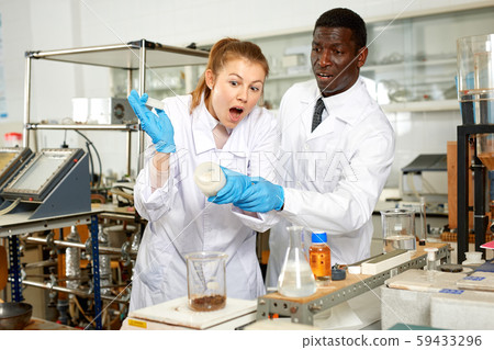 Worriend and scared male and female scientists after experiment 59433296