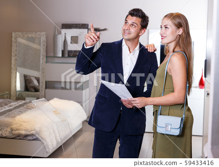 Family couple visiting salon of furniture Family couple visiting salon of furniture 59433416