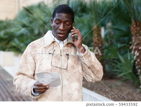 Portrait of man talking on phone Portrait of man talking on phone 59433592