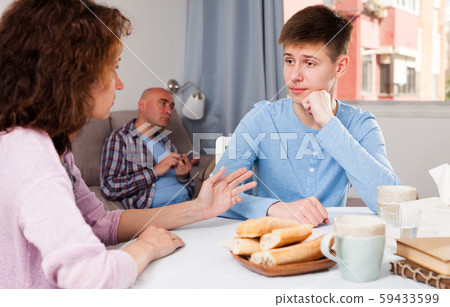 Teenager listening to reprimanding mother 59433599