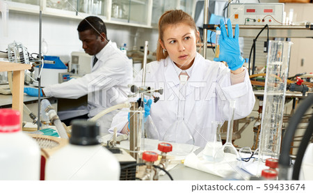 Woman scientist working in research laboratory with collegues Woman scientist working in research laboratory with collegues 59433674