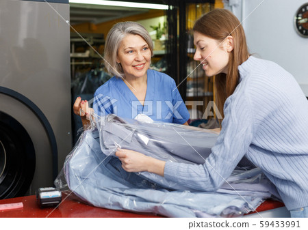 Woman receiving her clean menswear Woman receiving her clean menswear 59433991