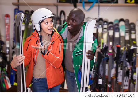 Nice African guy and European girl buying skis Nice African guy and European girl buying skis 59434104
