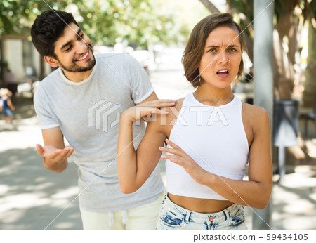 portrait of young male and female talking emotional at the street portrait of young male and female talking emotional at the street 59434105