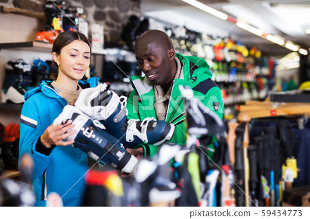 couple choosing new comfortable ski boots couple choosing new comfortable ski boots 59434773