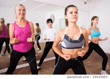 Fitness women practicing zumba movements Fitness women practicing zumba movements 59434965