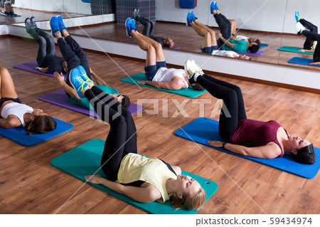 Adults having yoga class in sport club 59434974