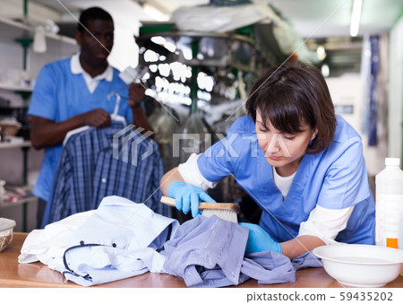 Female laundry worker during daily work Female laundry worker during daily work 59435202