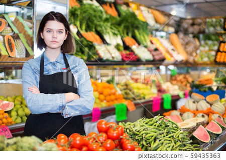Female seller displaying assortment 59435363