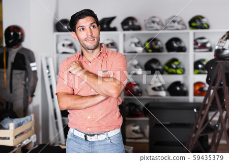 Portrait of male customer who is posing in the moto store. 59435379