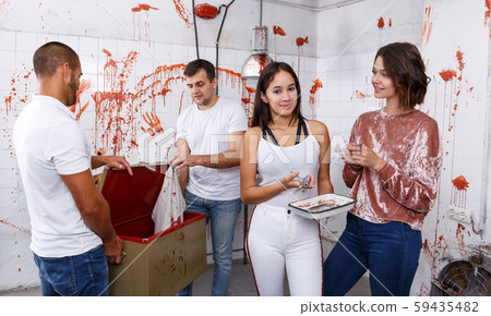 Young people in lost room with bloody walls 59435482
