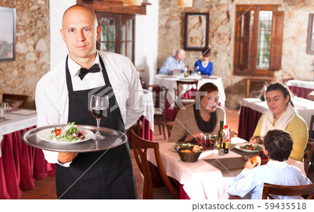 Waiter in white shirt holding tray Waiter in white shirt holding tray 59435518