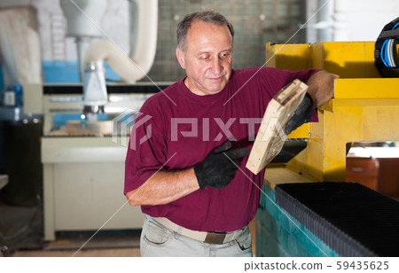 Foreman checks metal part on the wooden form Foreman checks metal part on the wooden form 59435625