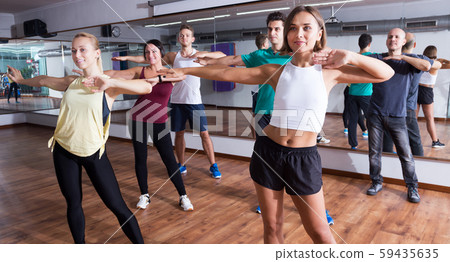 Men and ladies dancing zumba 59435635