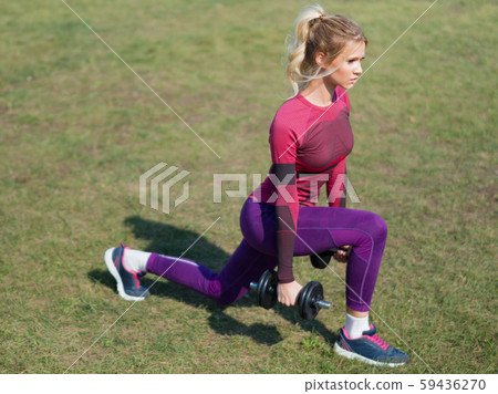 Woman in outdoor doing exercise for legs. Beautiful sport fitness model outside on summer or spring 59436270