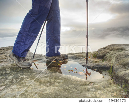 Hiker walks on Trail in warm trousers and Hiker walks on Trail in warm trousers and 59436373