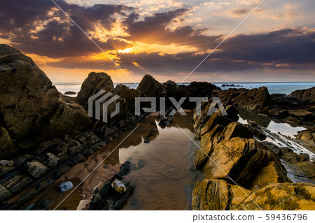 Flysch rocks in Barrika beach at the sunset. Travel in Spain. Flysch rocks in Barrika beach at the sunset. Travel in Spain. 59436796