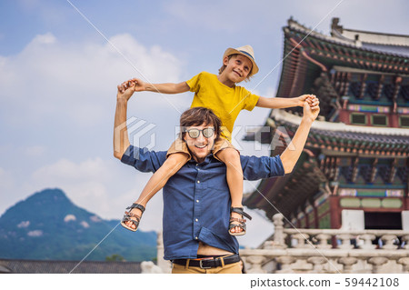 Dad and son tourists in Korea. Gyeongbokgung Palace grounds in Seoul, South Korea. Travel to Korea Dad and son tourists in Korea. Gyeongbokgung Palace grounds in Seoul, South Korea. Travel to Korea 59442108